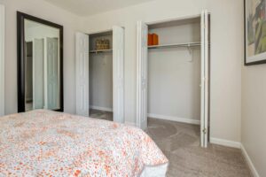 Neutral toned carpeting, full length mirror, 2 closet openings